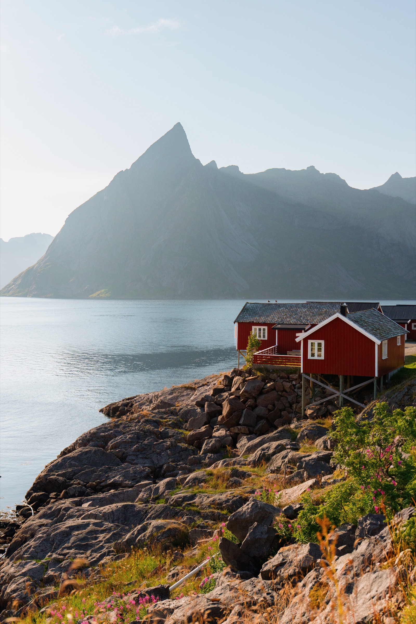 Red cabin below a dramatic mountain ridge