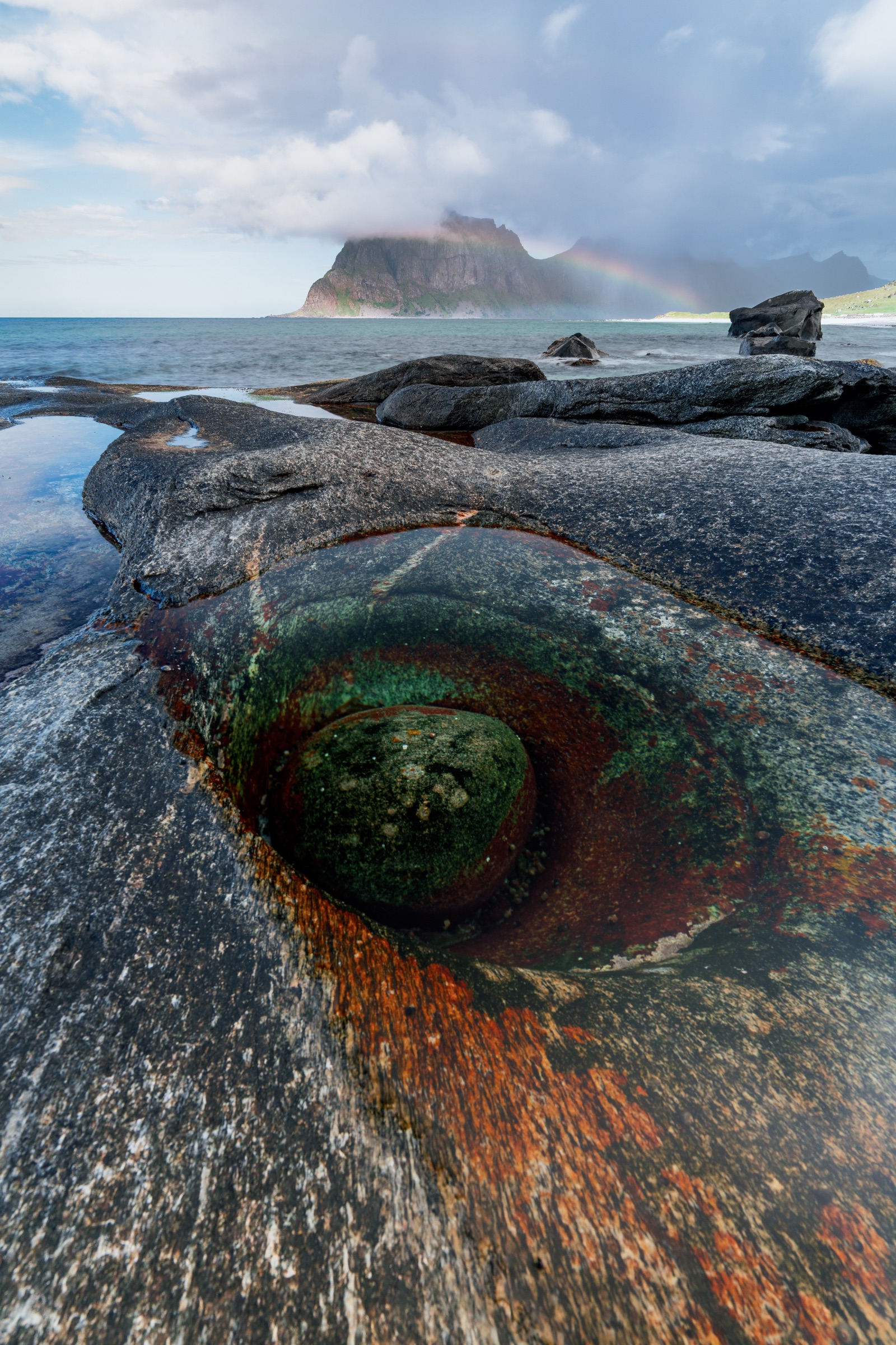 Colourful tidal pool in weathered coastal rock