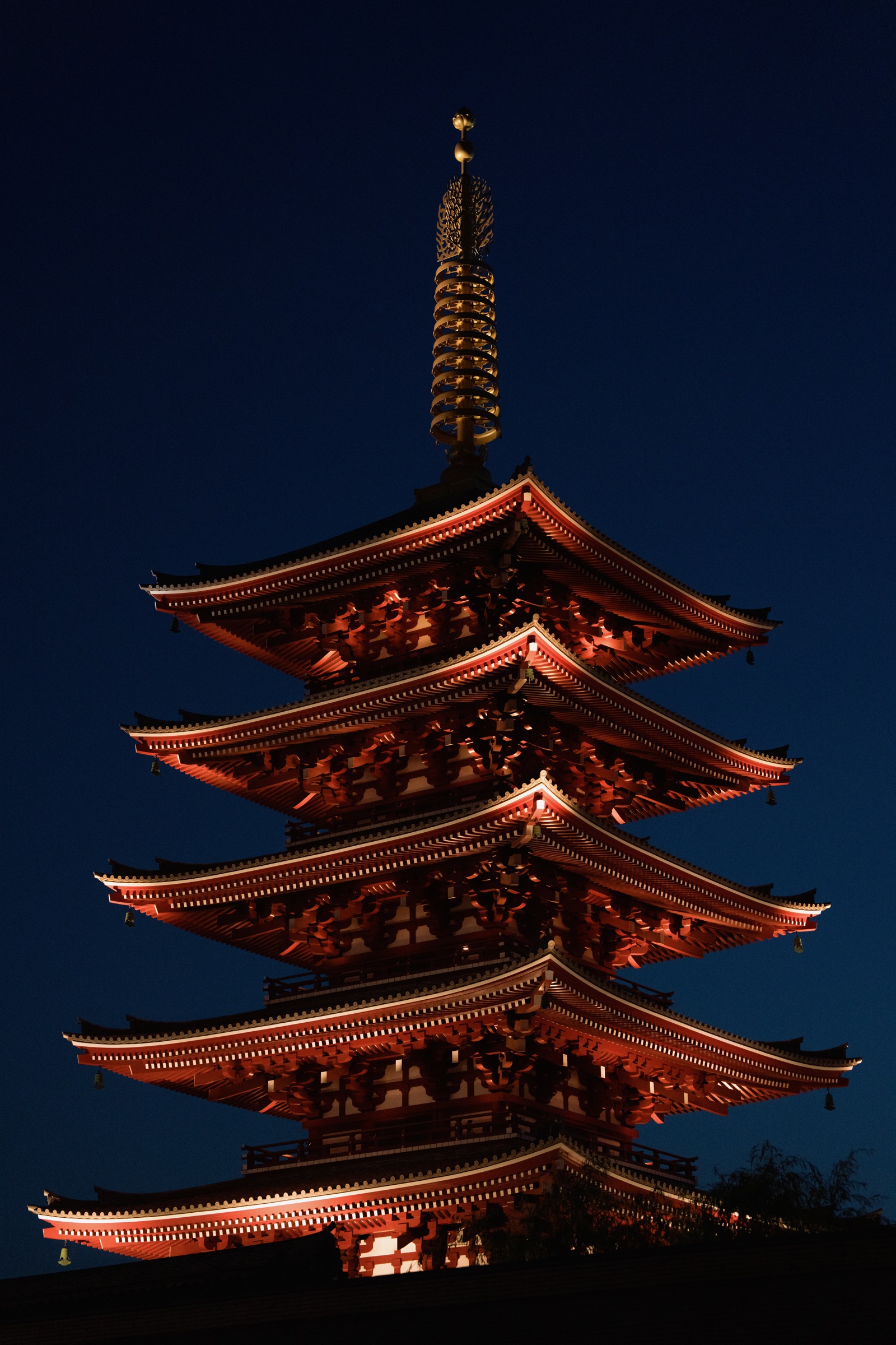 Illuminated Japanese pagoda against the night sky